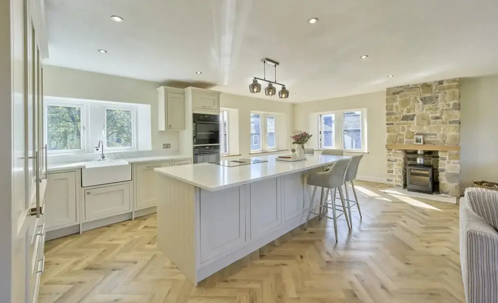 Linton kitchen - island through to the stone fireplace
